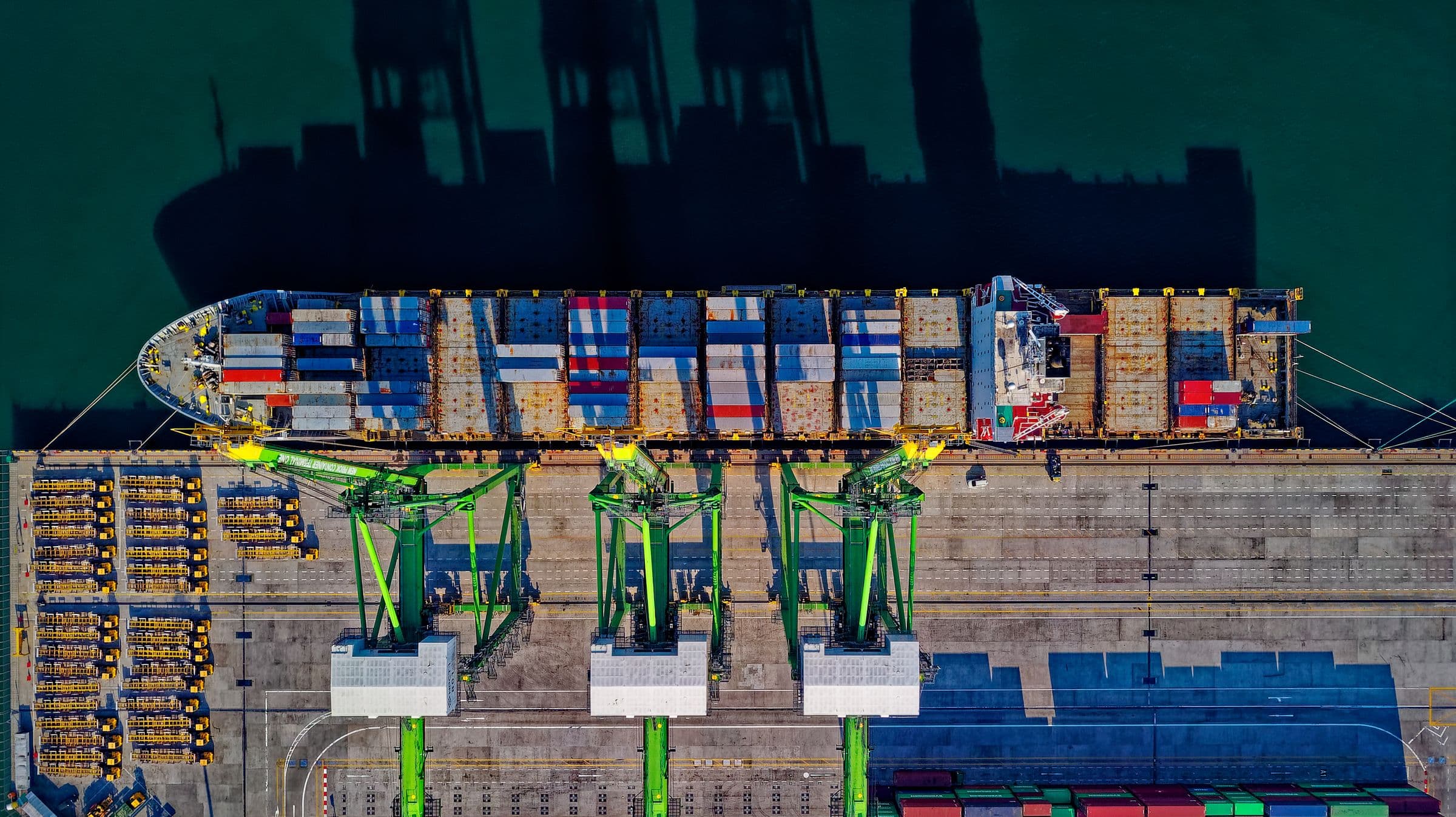 Aerial view of a container ship being worked at port